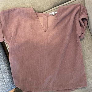 Mauve colored corduroy short sleeved shirt with buttons down the back